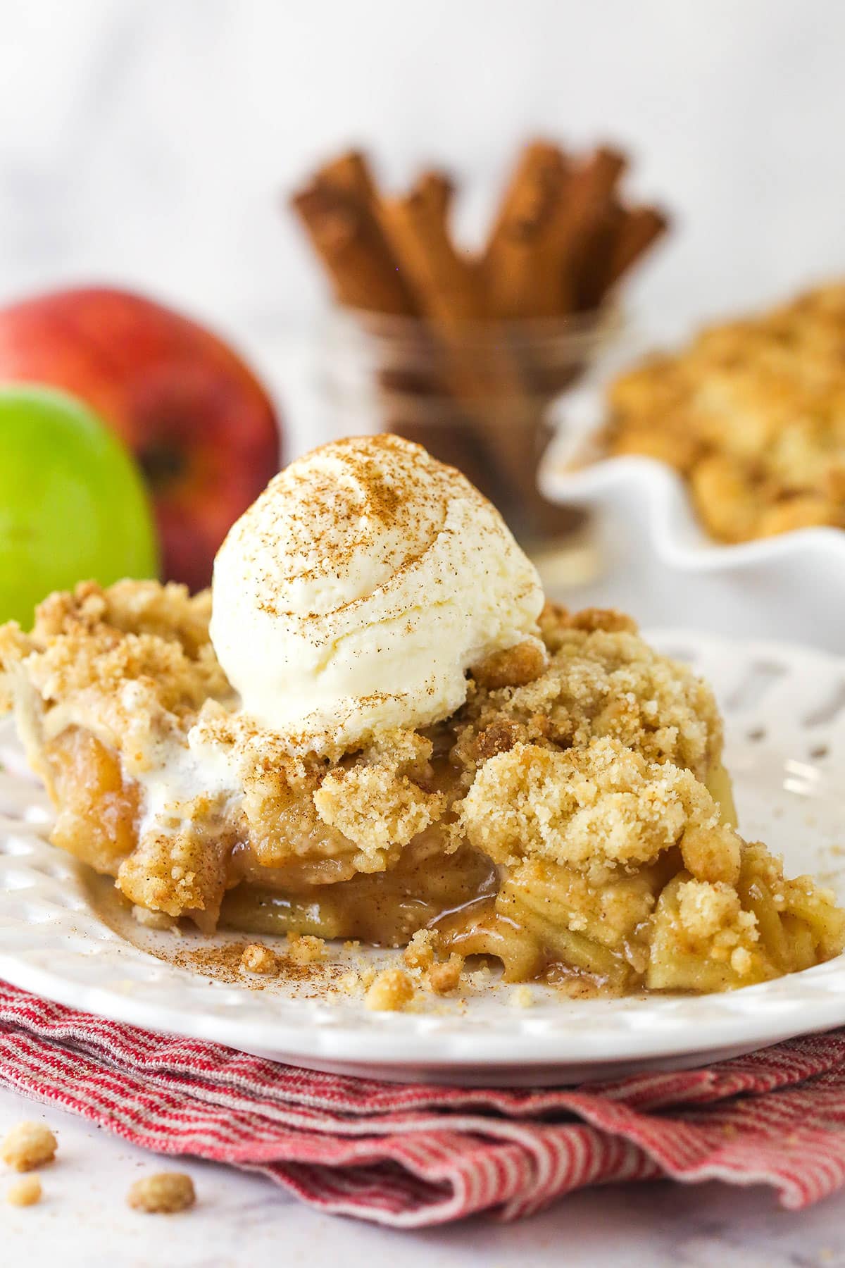 A slice of Dutch apple pie with ice cream