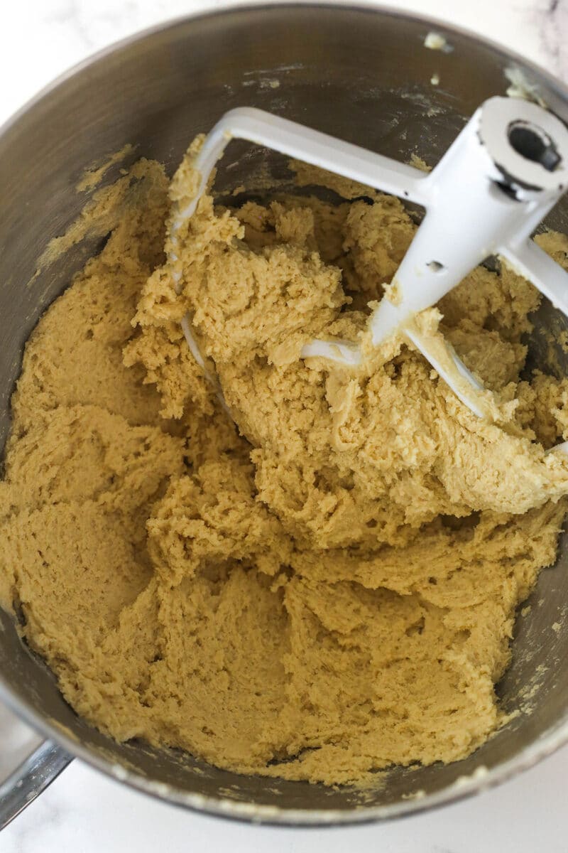 Maple cookie bar batter in a metal mixing bowl with the dry ingredients mixed in.