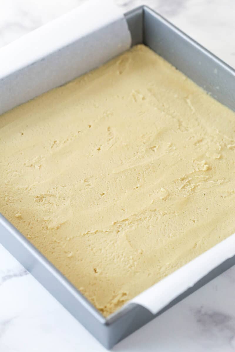 A pan with maple cookie bar batter spread into it.