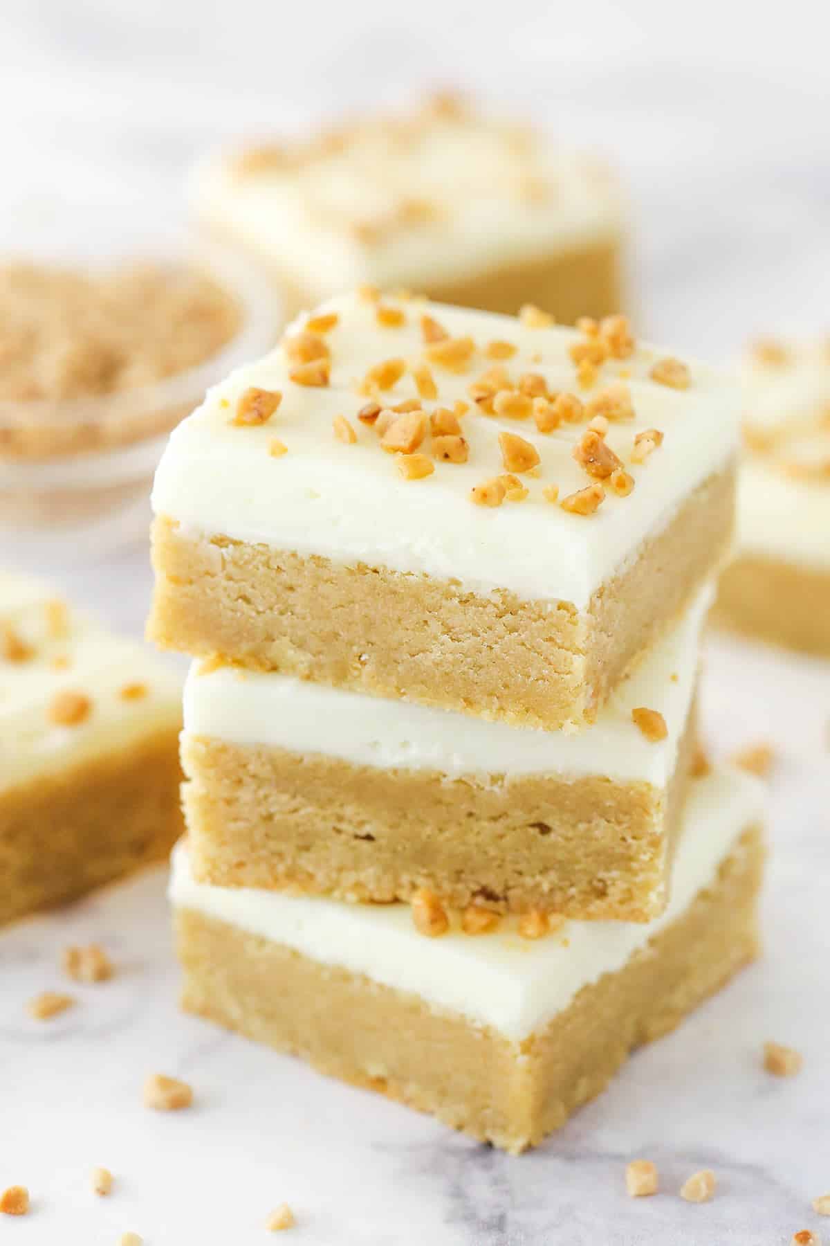 A stack of frosted maple cookie bars.