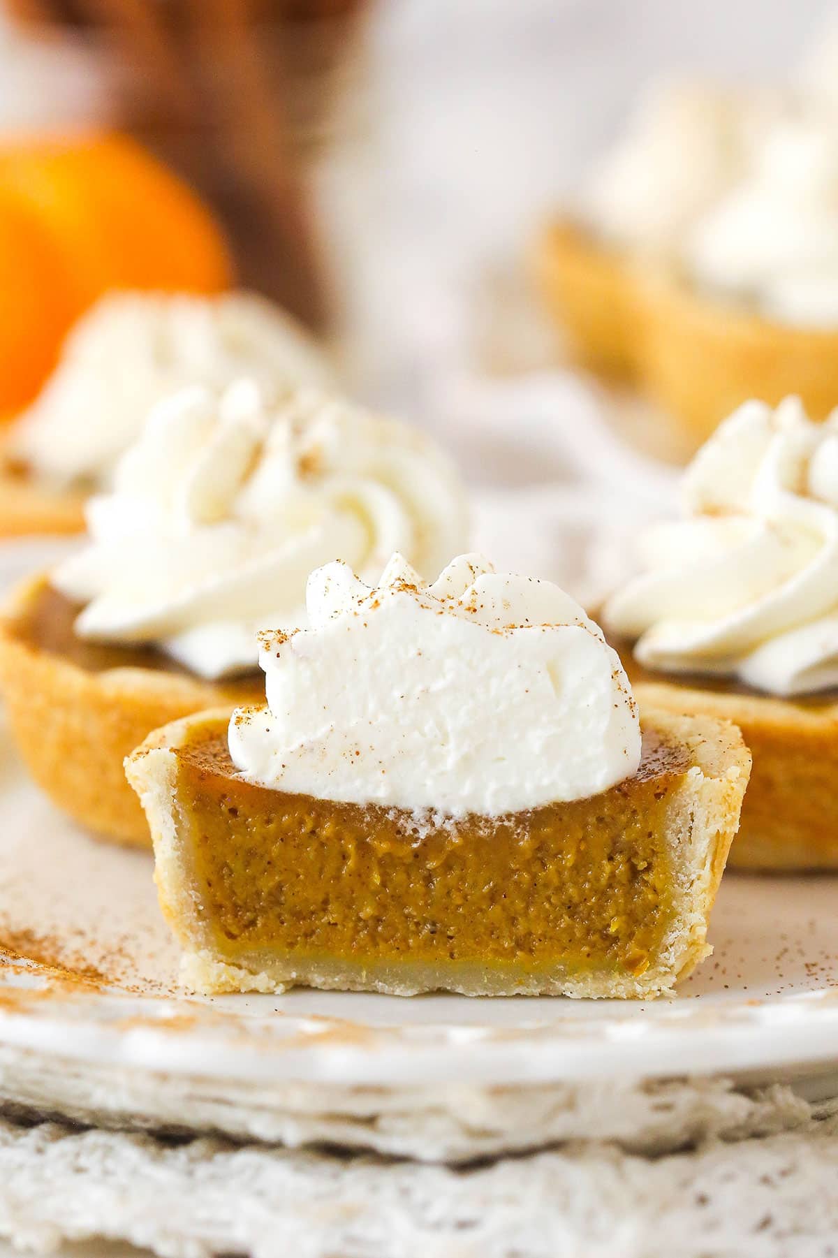 Front view of a mini pumpkin pie cut in half to see the pumpkin filling