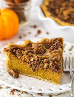 A slice of pecan praline pumpkin pie on a white plate