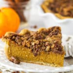 A slice of praline pumpkin pie on a white plate.