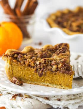 A slice of praline pumpkin pie on a white plate.