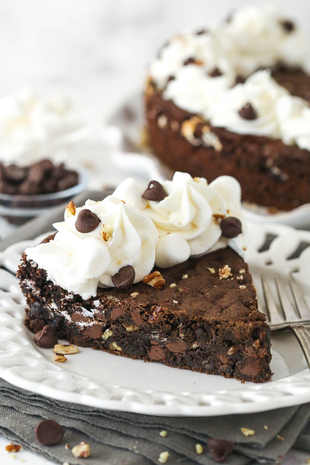 A slice of Rocky Road Cookie Cake on a small white plate. 