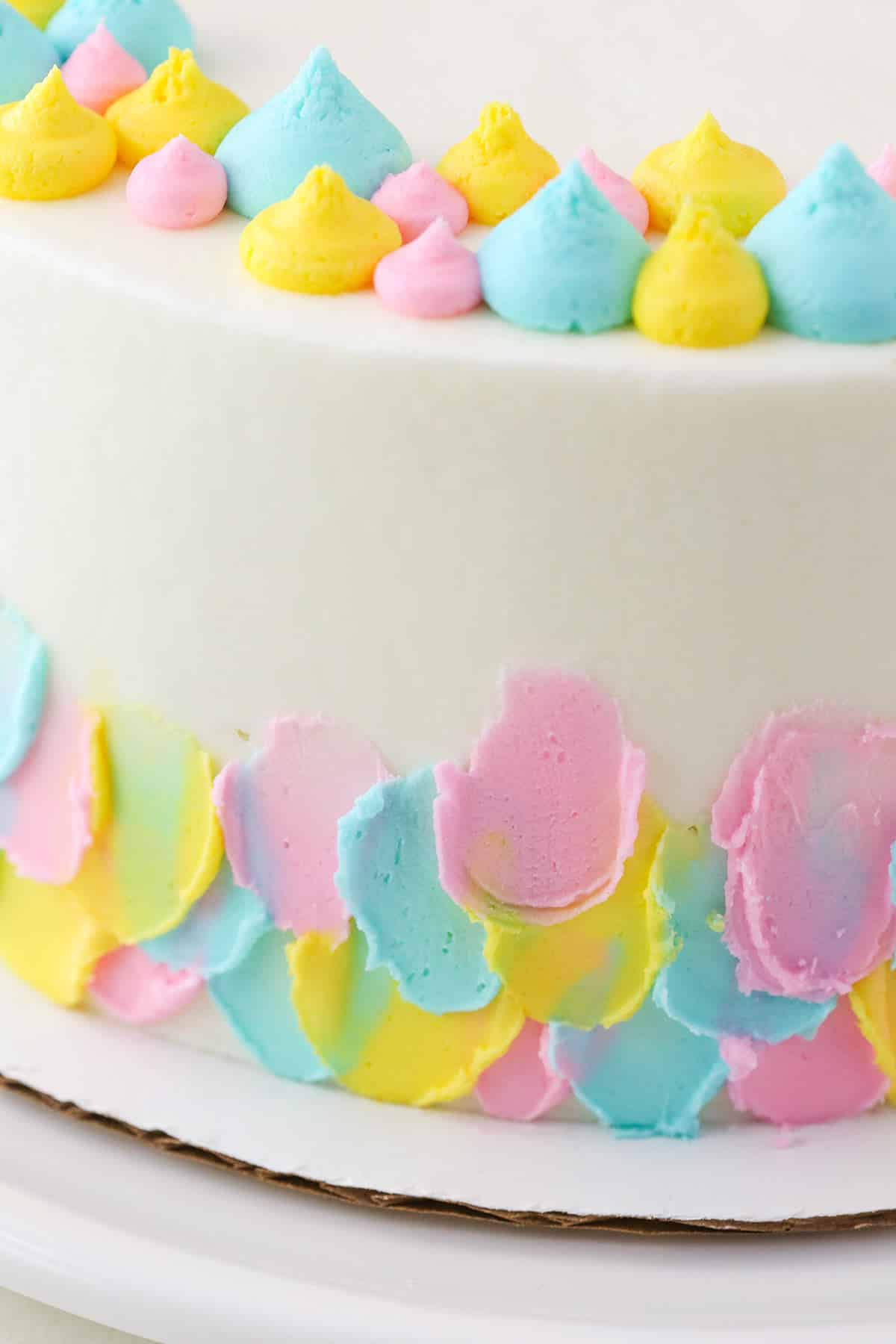 Closeup of frosting applied to the side of an Almond Custard Layer Cake