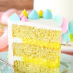 A slice of Almond Custard Layer Cake next to a fork on a light blue plate