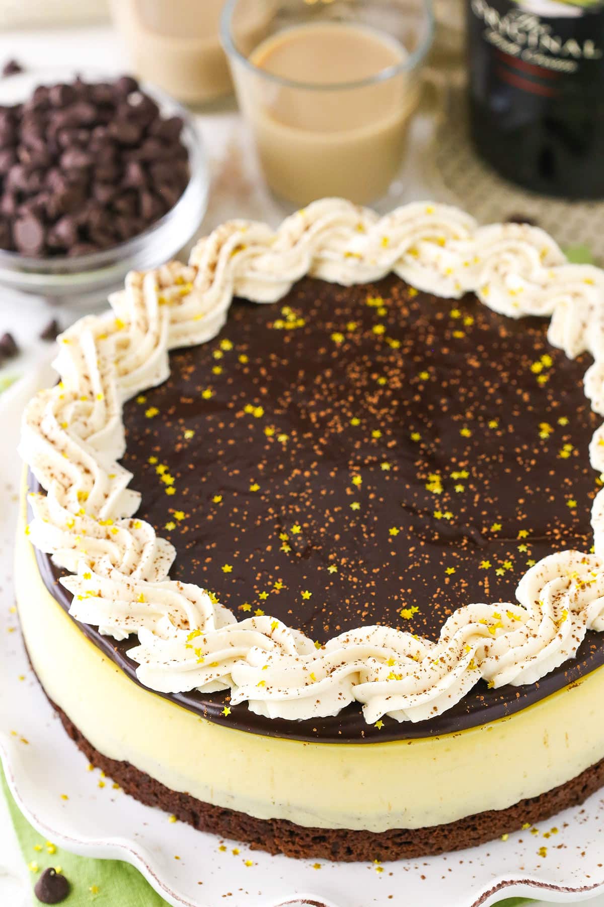 Overhead view of a full Baileys Brownie Cheesecake on a white platter