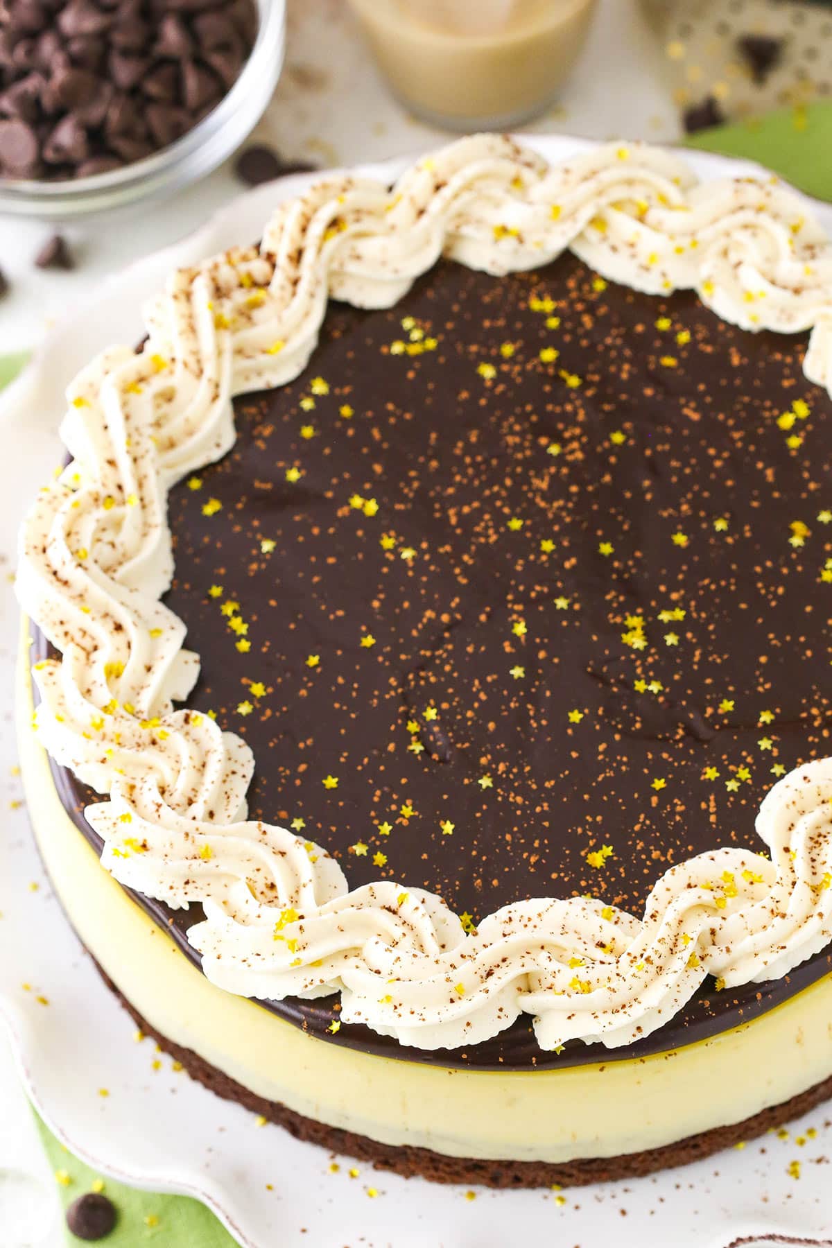 Overhead view of a full Baileys Brownie Cheesecake on a white platter