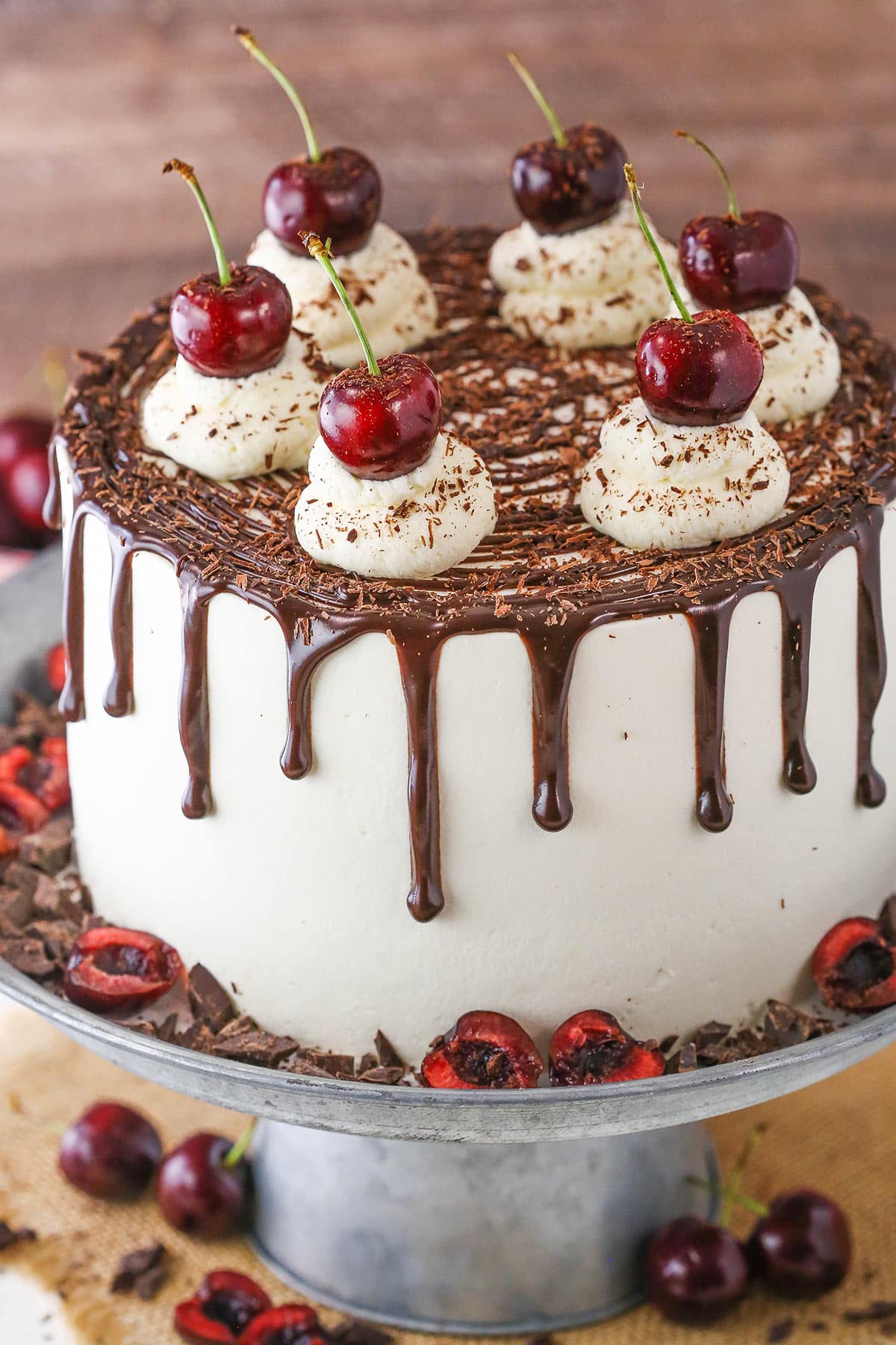 A full Black Forest Cake on a gray cake stand