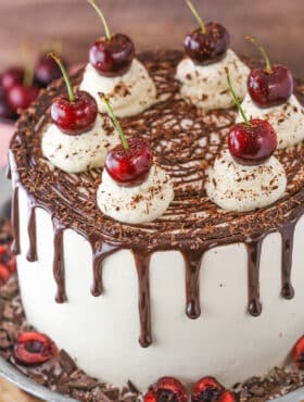 A full Black Forest Cake on a gray cake stand