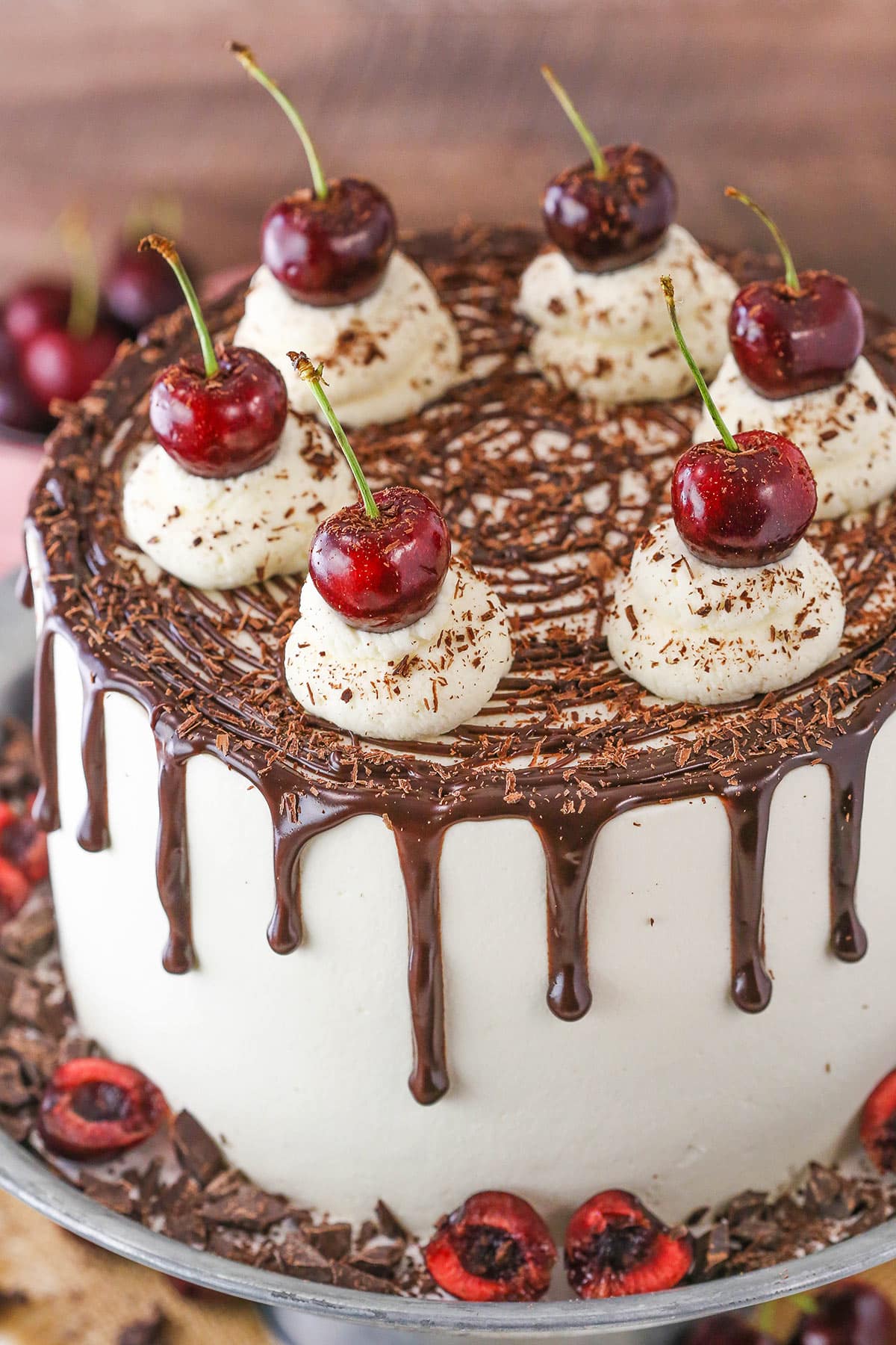 A full Black Forest Cake on a gray cake stand