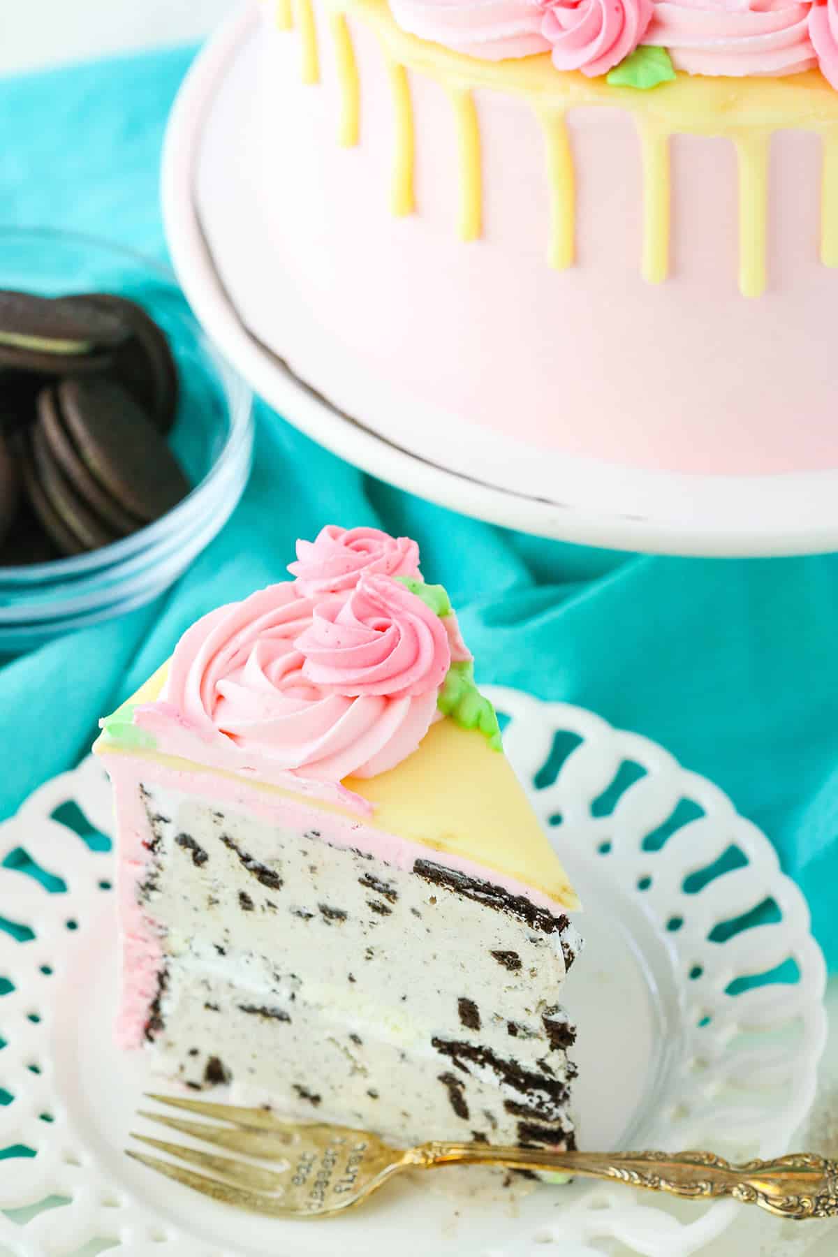 A slice of Carvel Cake next to a fork on a white plate