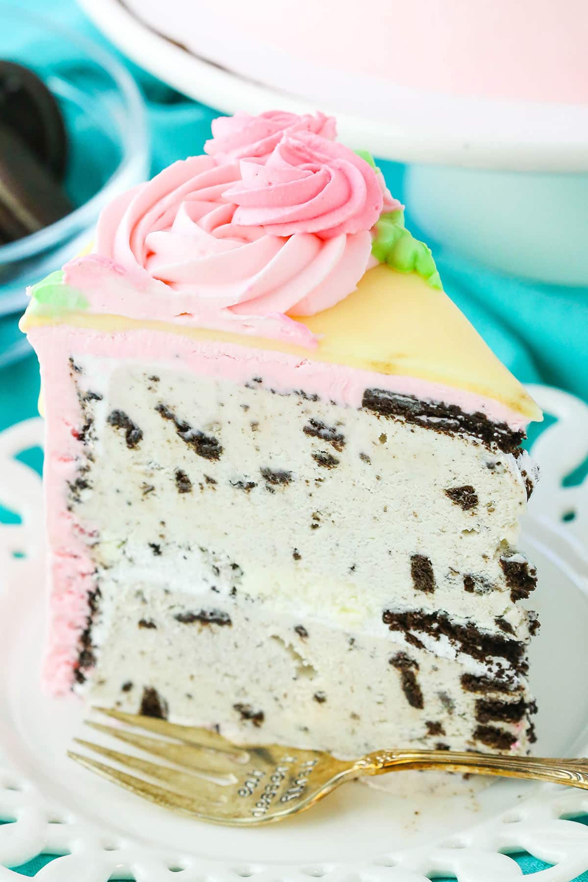 A slice of Carvel Cake next to a fork on a white plate