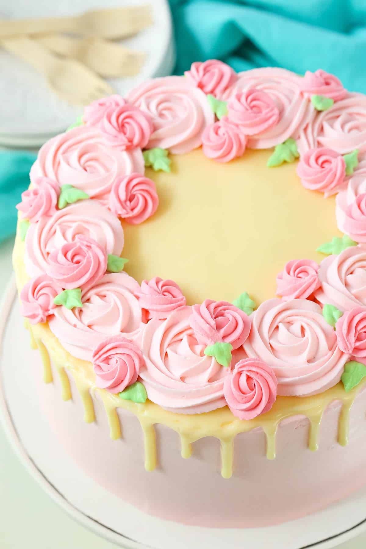 Overhead view of a full Carvel Cake with pink swirls on a white cake stand