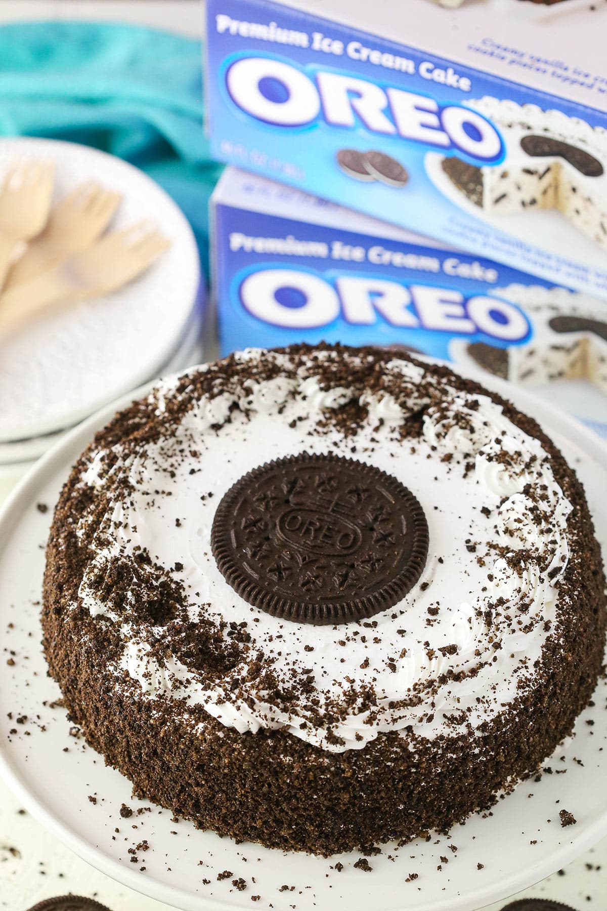 A full Oreo Ice Cream Cake on a white cake stand