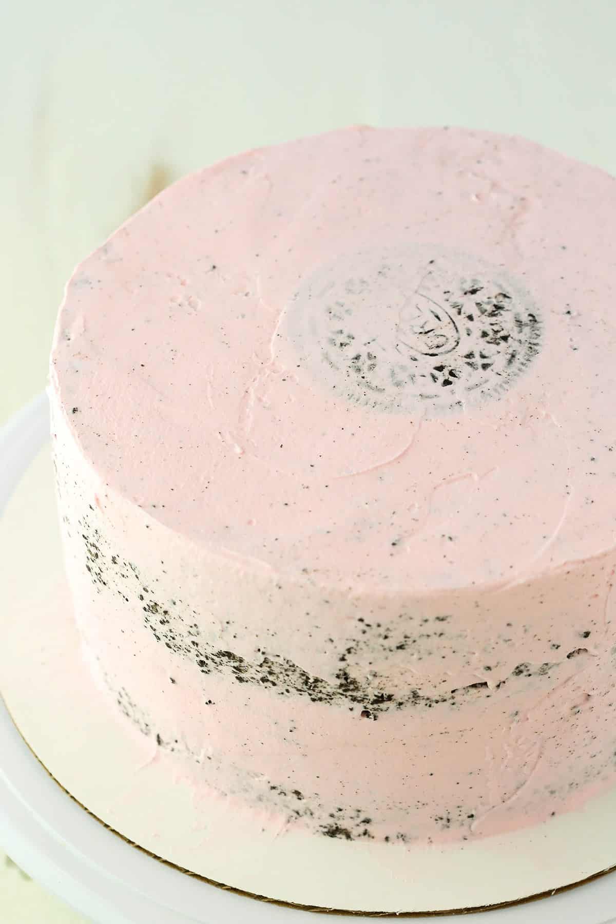 An Oreo Ice Cream Cake completely covered with pink frosting