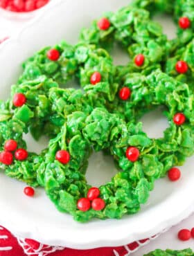 Christmas cornflake wreath cookies on a white plate