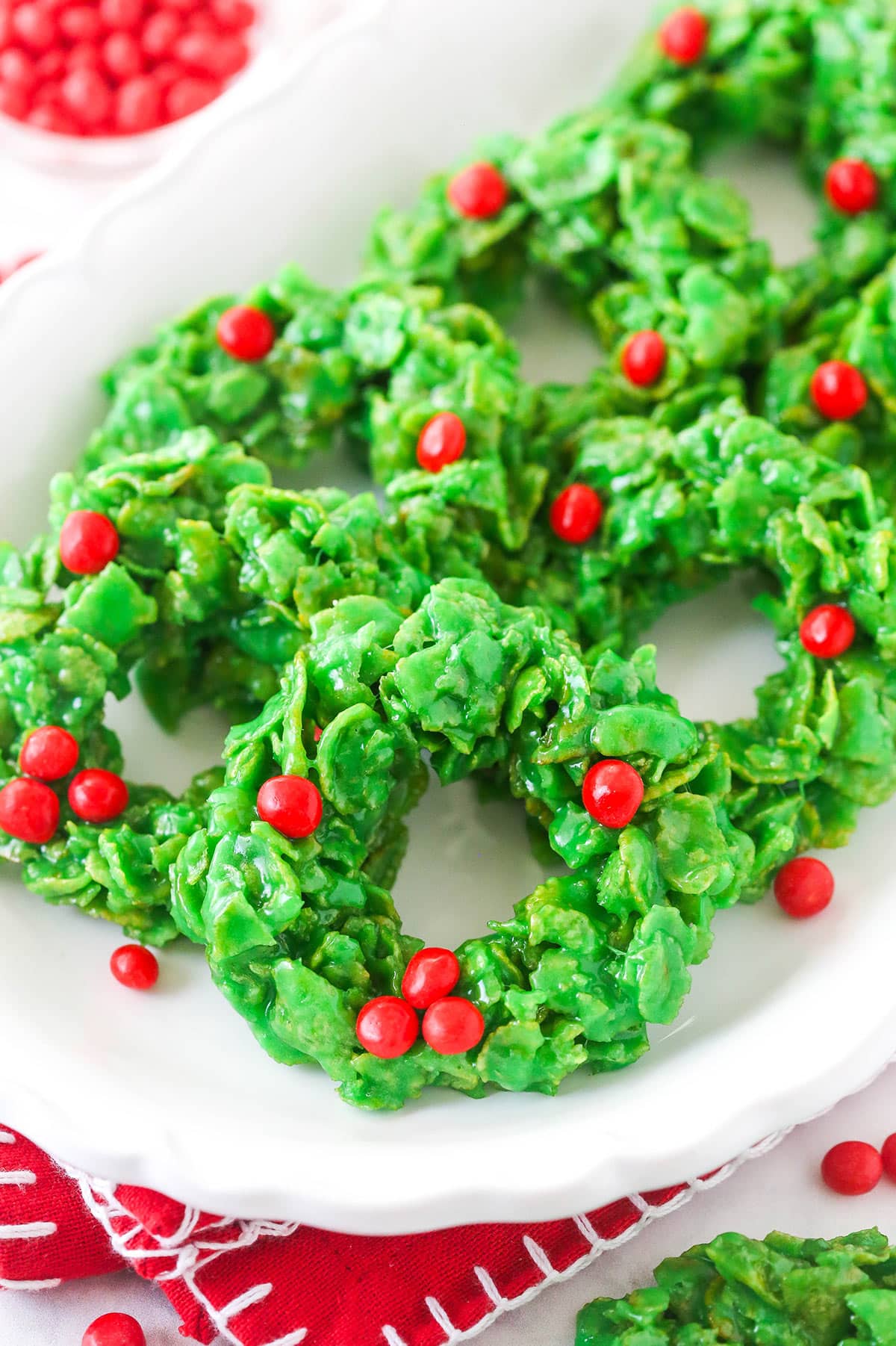 Christmas cornflake wreath cookies on a white plate