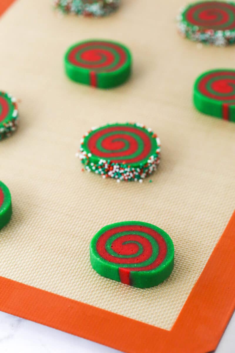 Unbaked Christmas pinwheel cookies on a baking sheet