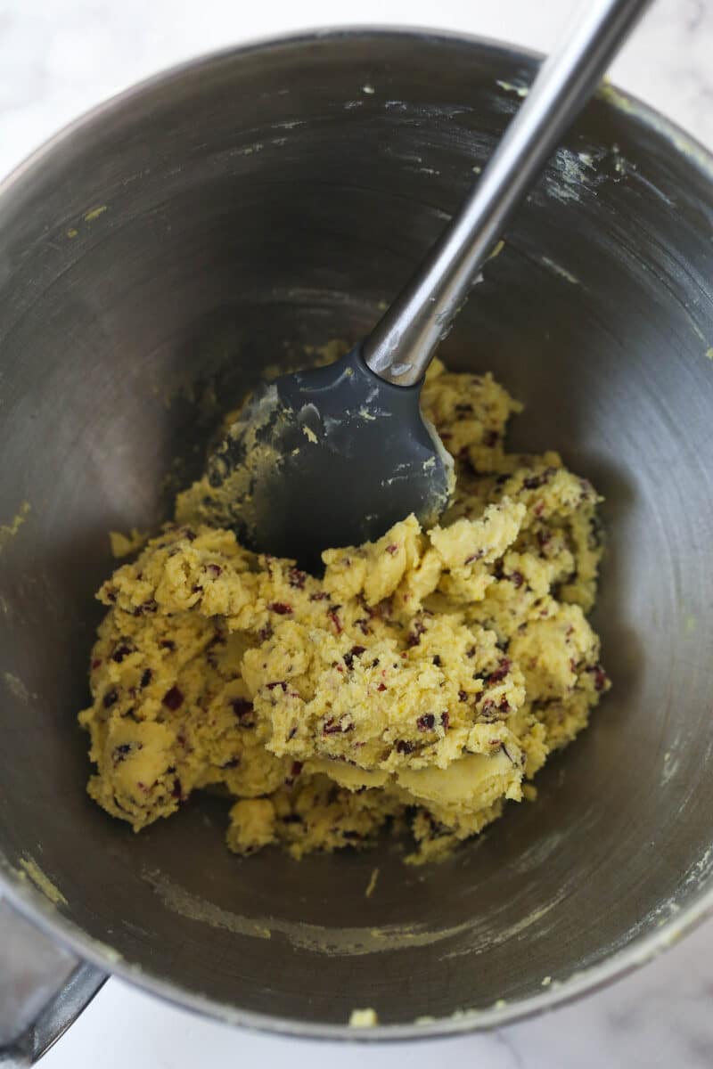 Mixing dried cranberries into shortbread dough