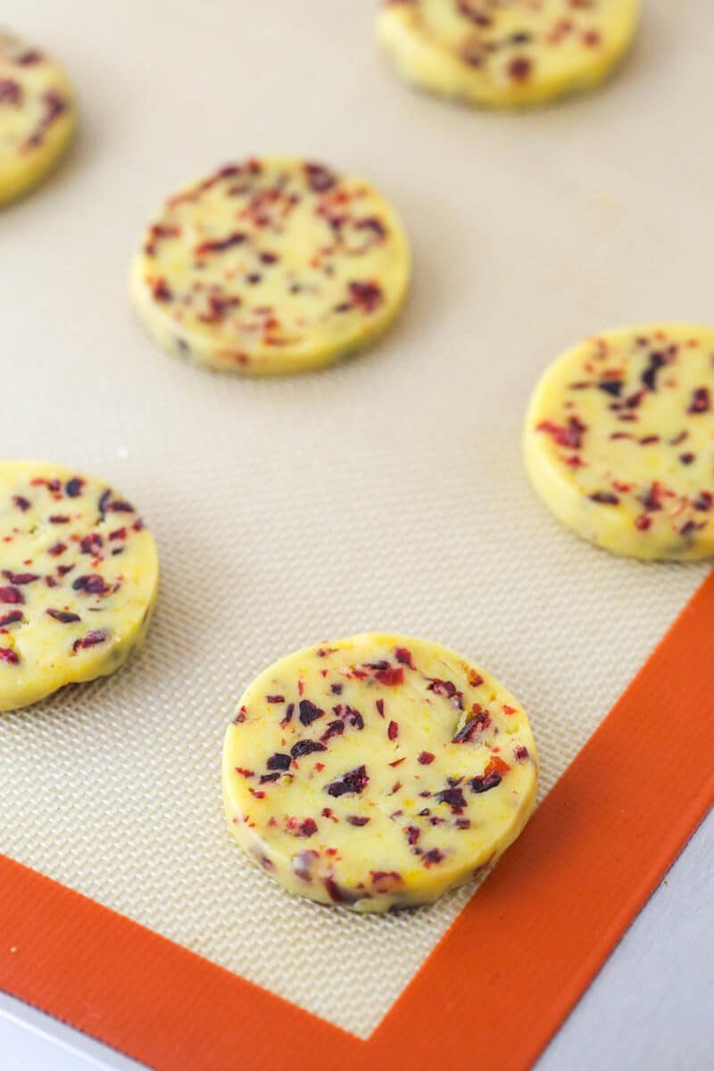 Unbaked cranberry orange shortbread on a baking sheet