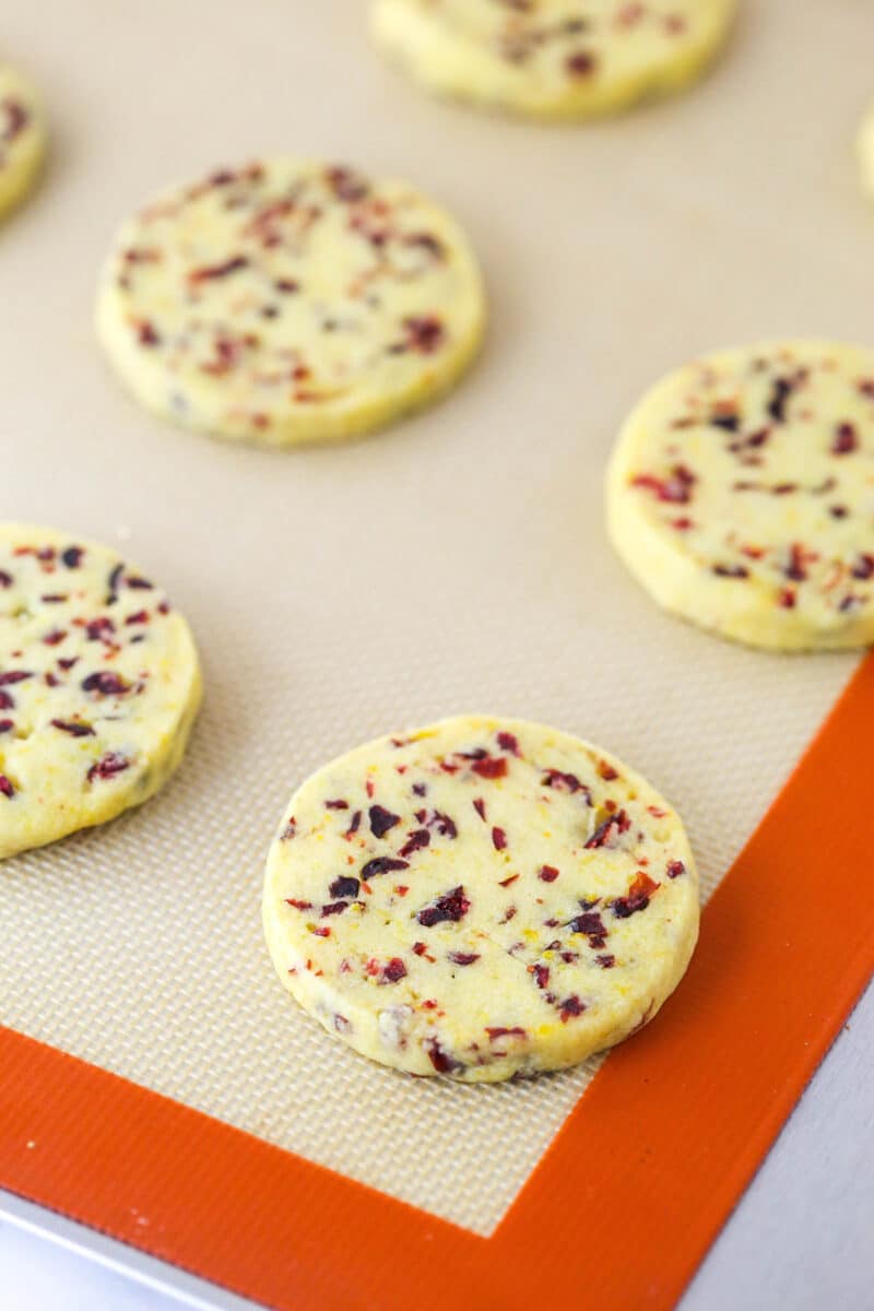 Baked cranberry orange shortbread cookies on a baking sheet