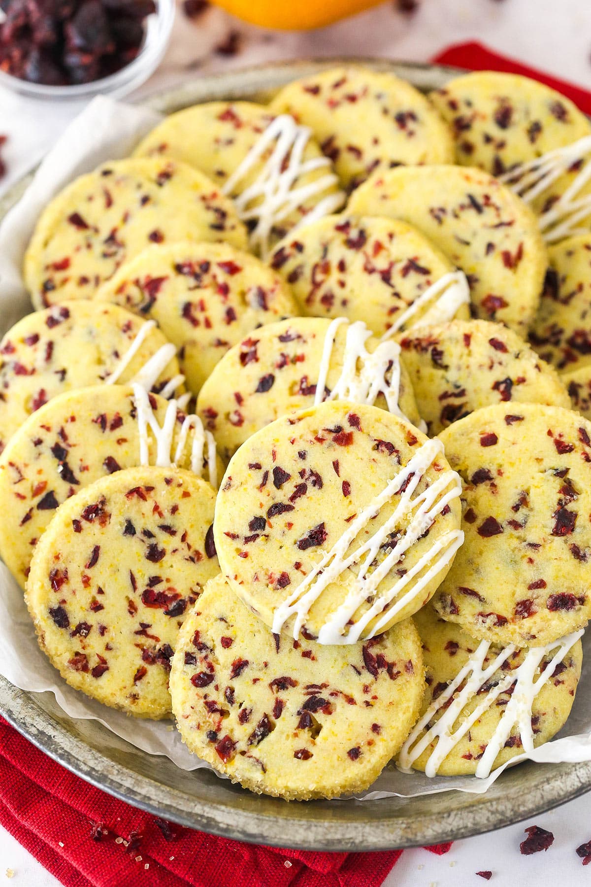 Overhead view of a plate of cranberry orange shortbread cookies