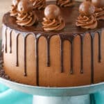 Side view of a full Drunken Chocolate Truffle Cake on a gray cake stand