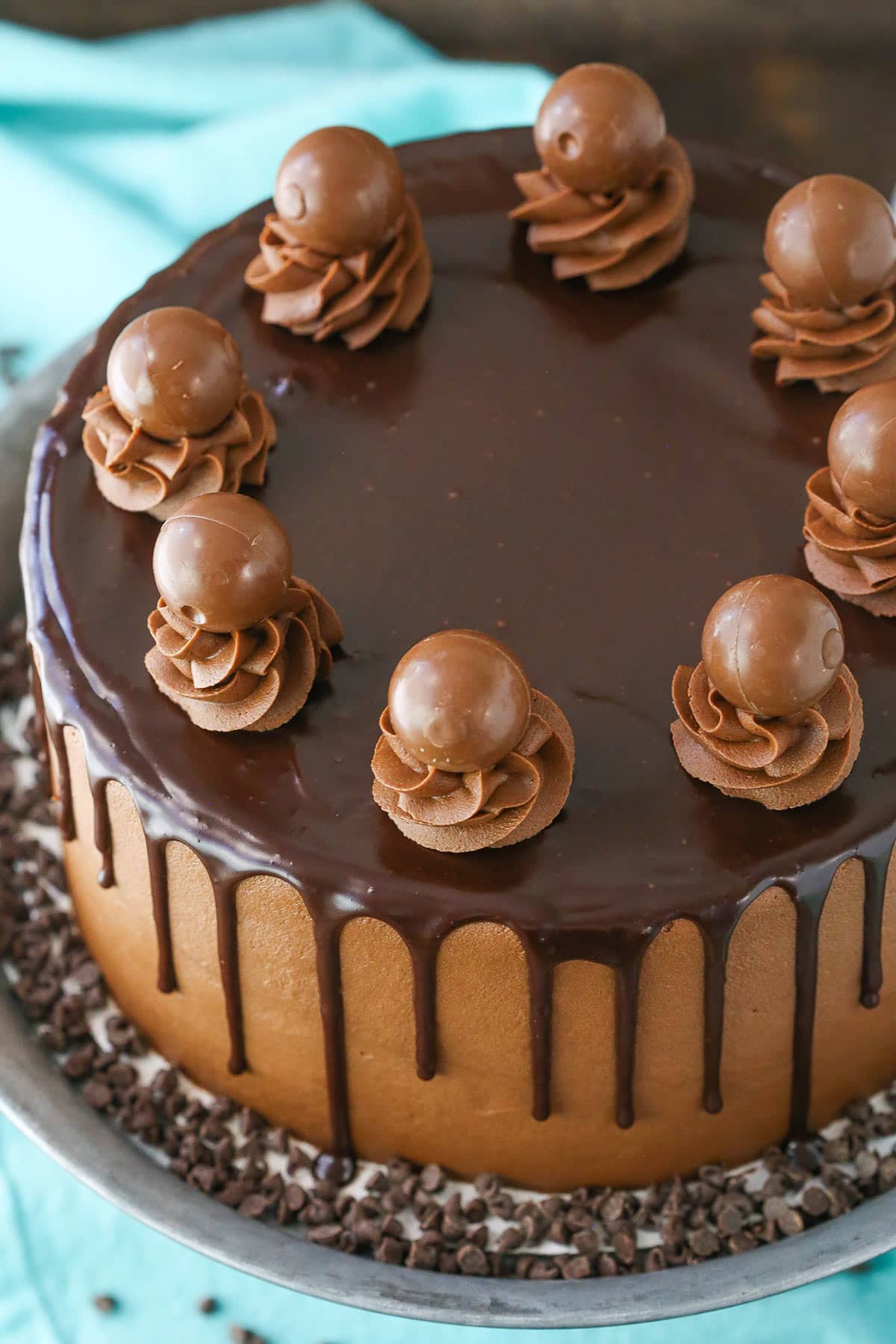 Overhead view of a full Drunken Chocolate Truffle Cake on a gray cake stand