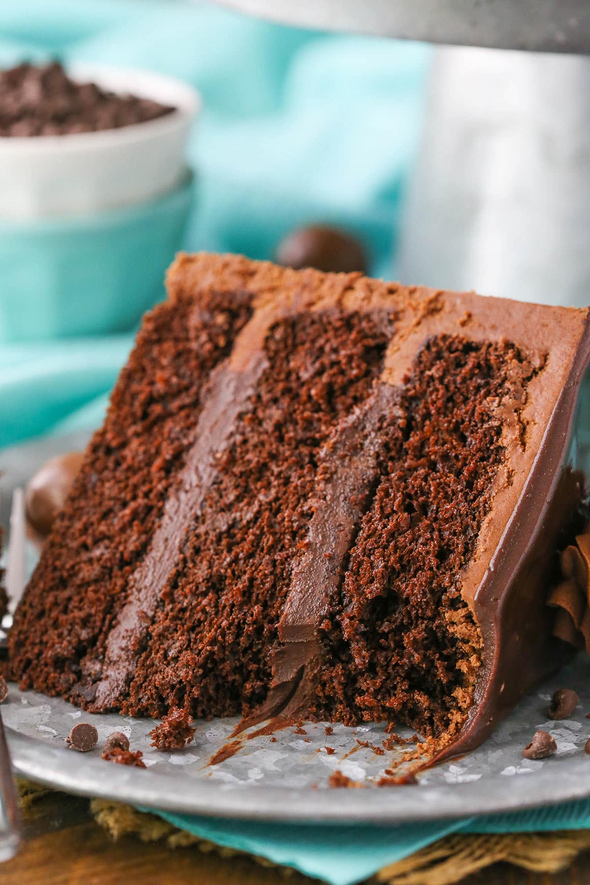 A slice of Drunken Chocolate Truffle Cake with a bite removed on a gray plate