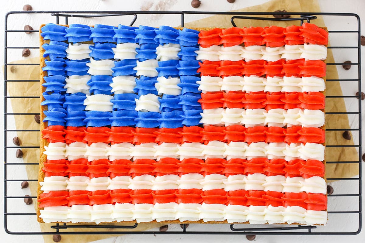 Overhead view of a full Flag Chocolate Chip Cookie Cake on a cooling rack