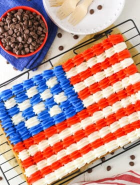 Overhead view of a full Flag Chocolate Chip Cookie Cake on a cooling rack