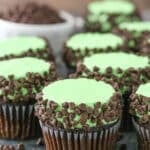 Side view of Mint Chocolate Chip Cupcakes on a gray plate