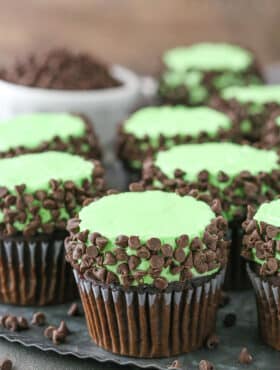 Side view of Mint Chocolate Chip Cupcakes on a gray plate