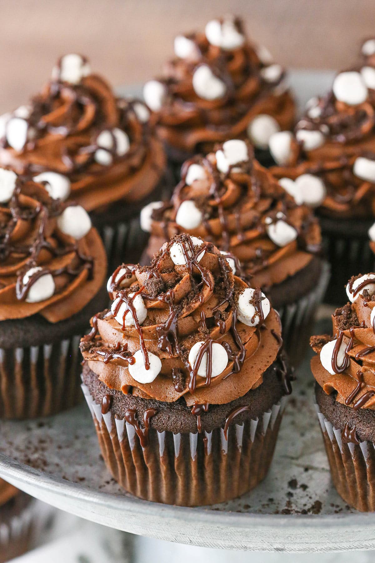 Mississippi Mud Cupcakes spread out on a gray cake stand