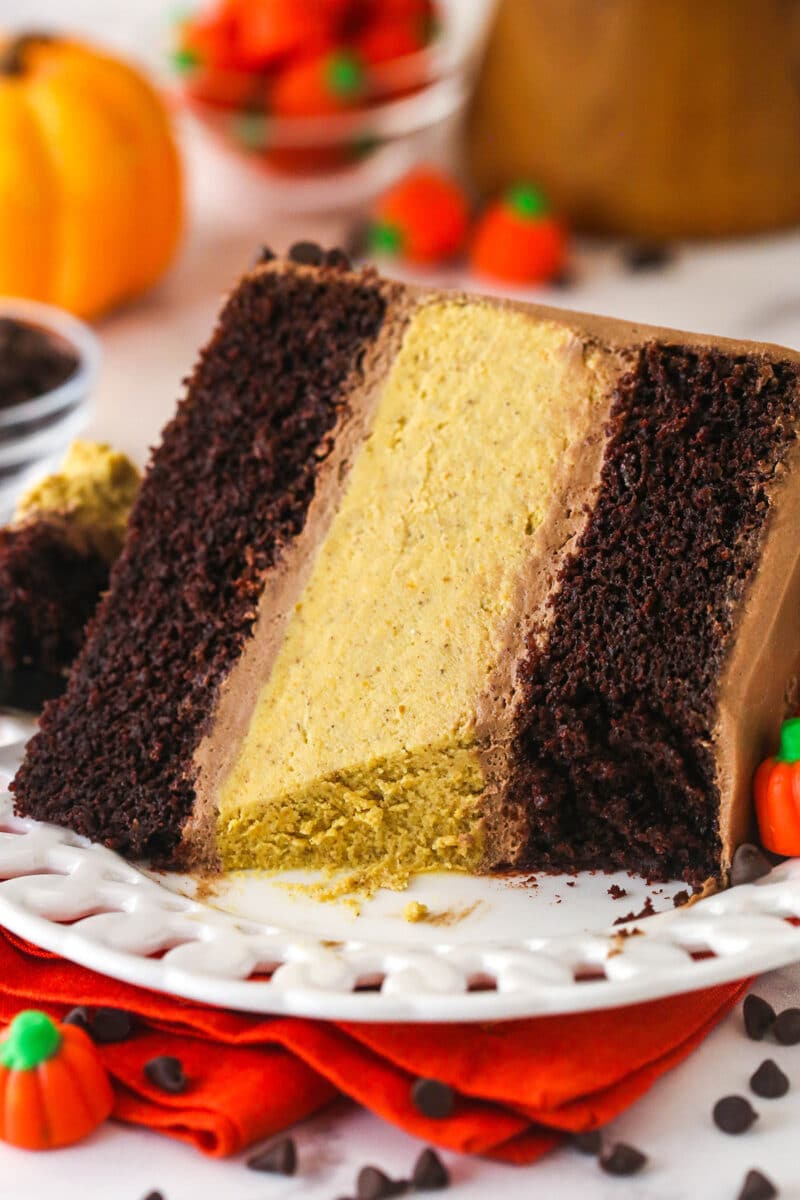 A slice of Chocolate Pumpkin Cheesecake Cake with bites removed.