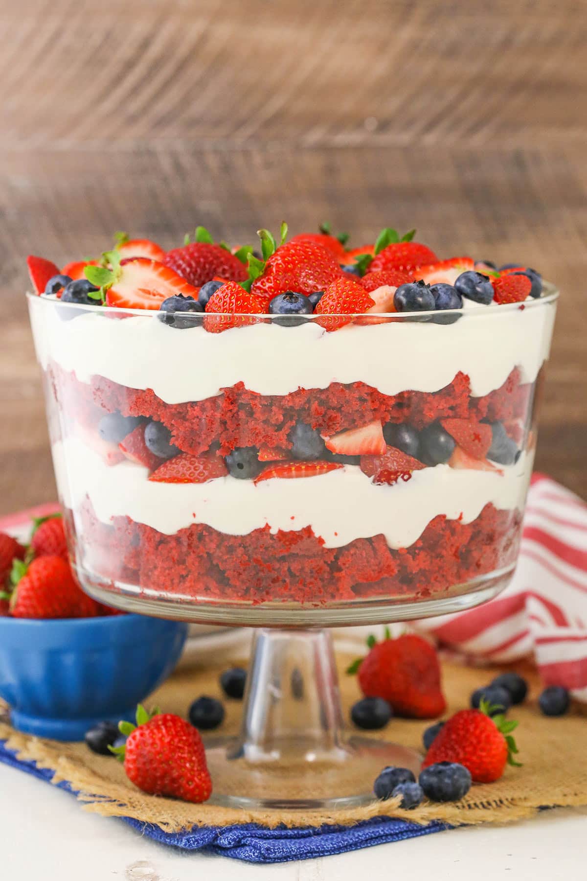 Side view of a full Red Velvet Berry Trifle in a clear glass trifle bowl