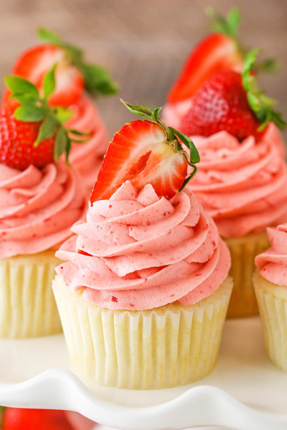 Strawberries and Cream Cupcakes on a white cake stand