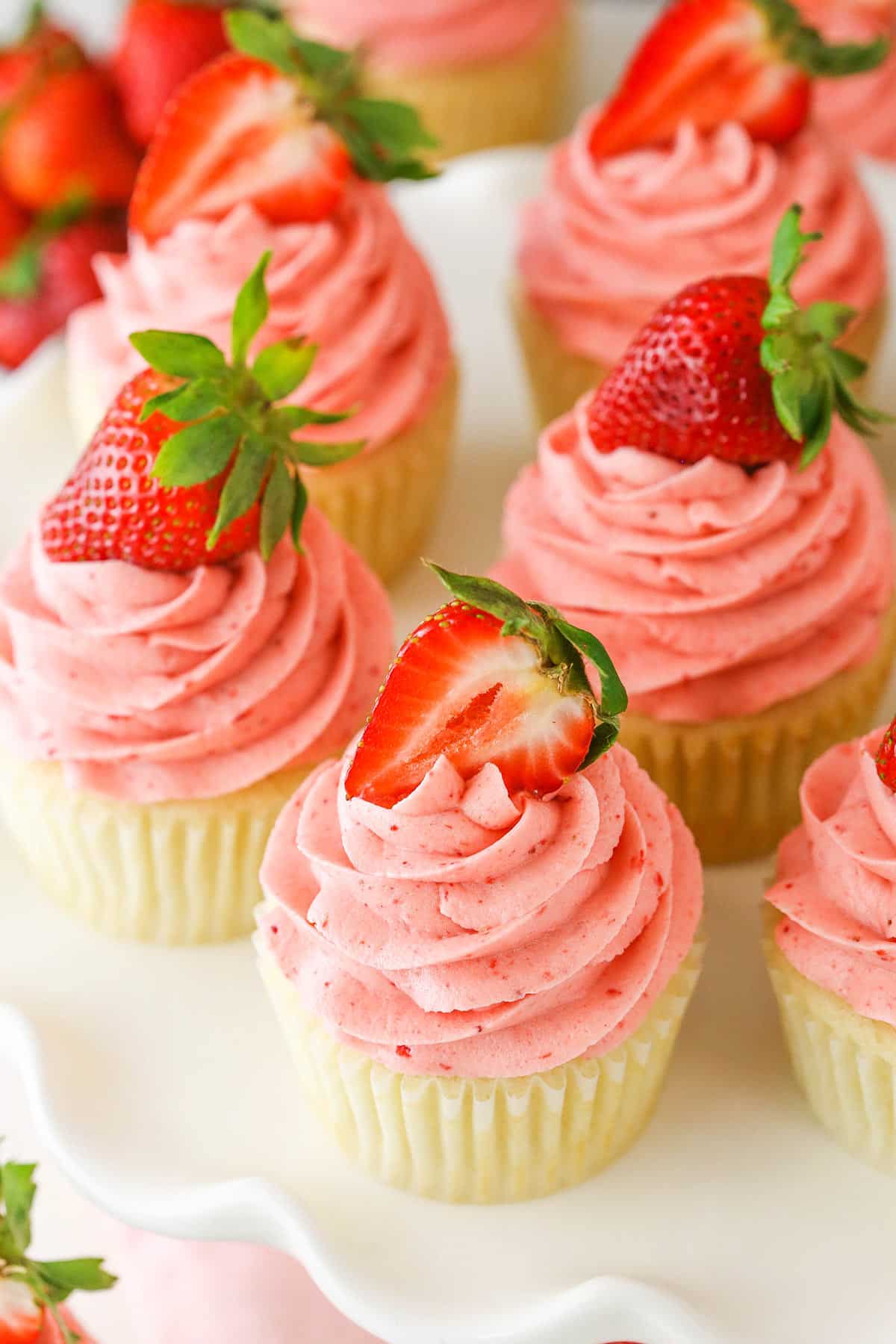 Overhead view of Strawberries and Cream Cupcakes on a white cake stand