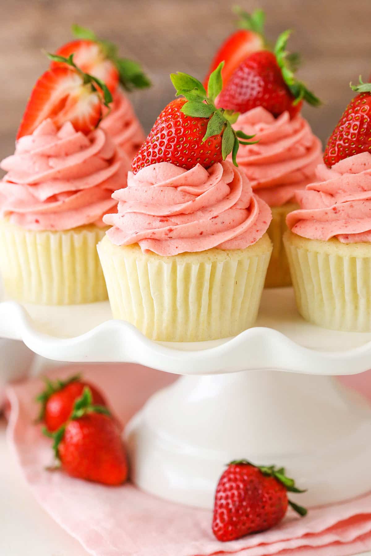 Strawberries and Cream Cupcakes on a white cake stand