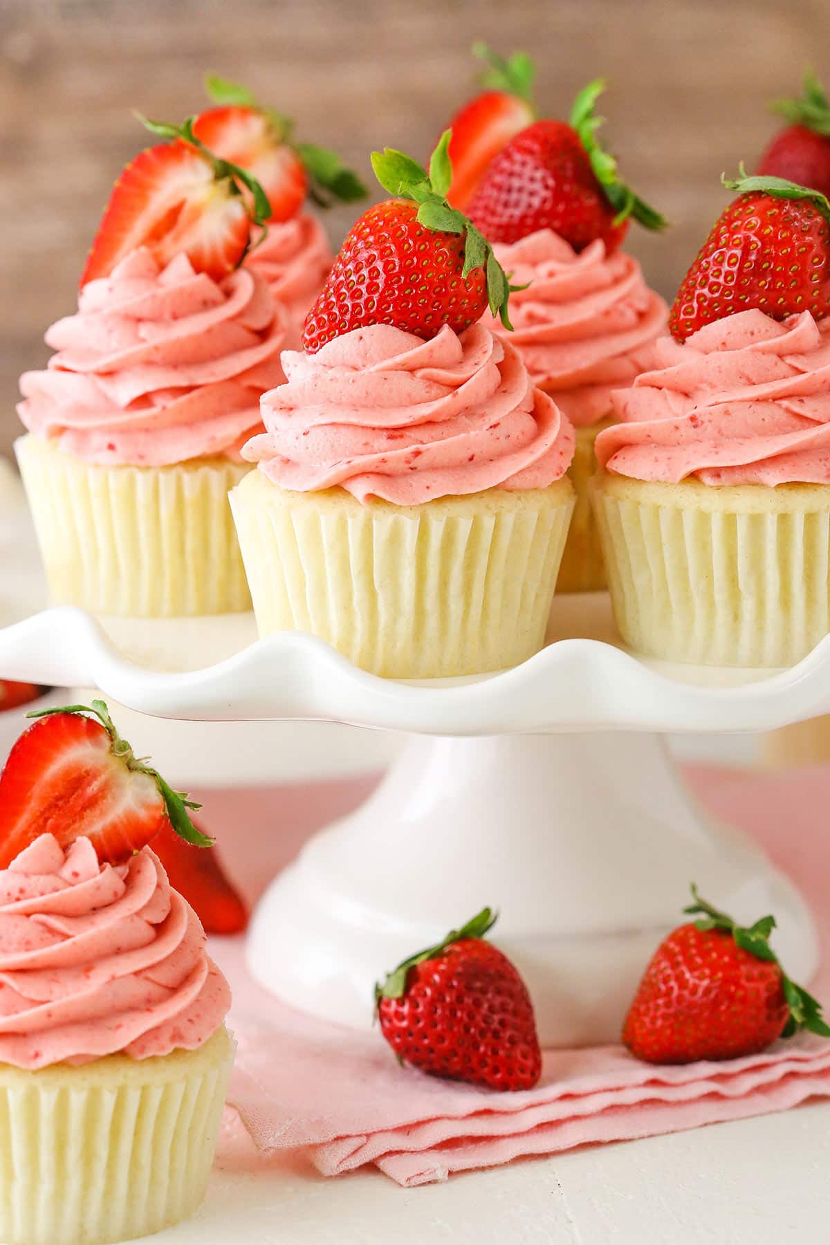 Strawberries and Cream Cupcakes on a white cake stand