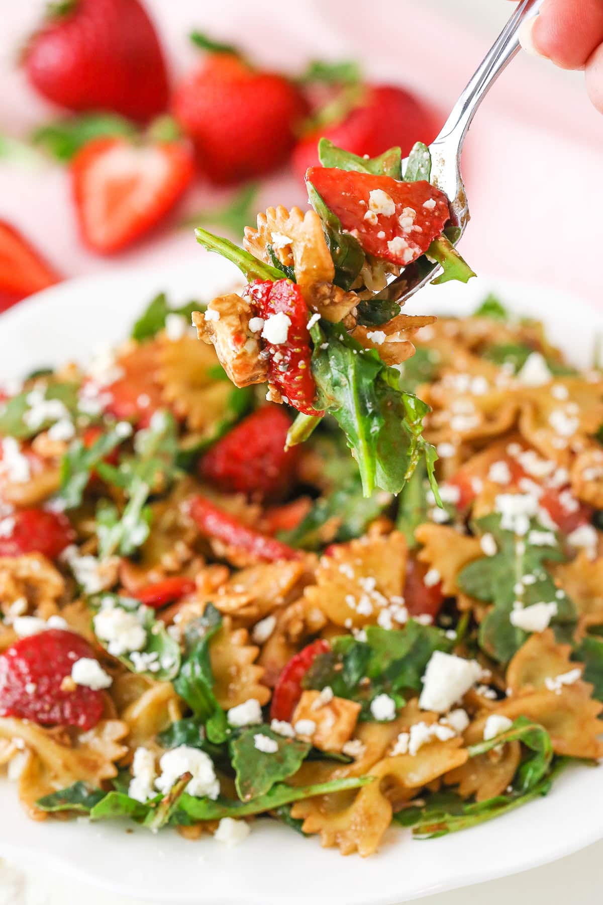 A bite of Strawberry Feta Balsamic Pasta Salad on a fork