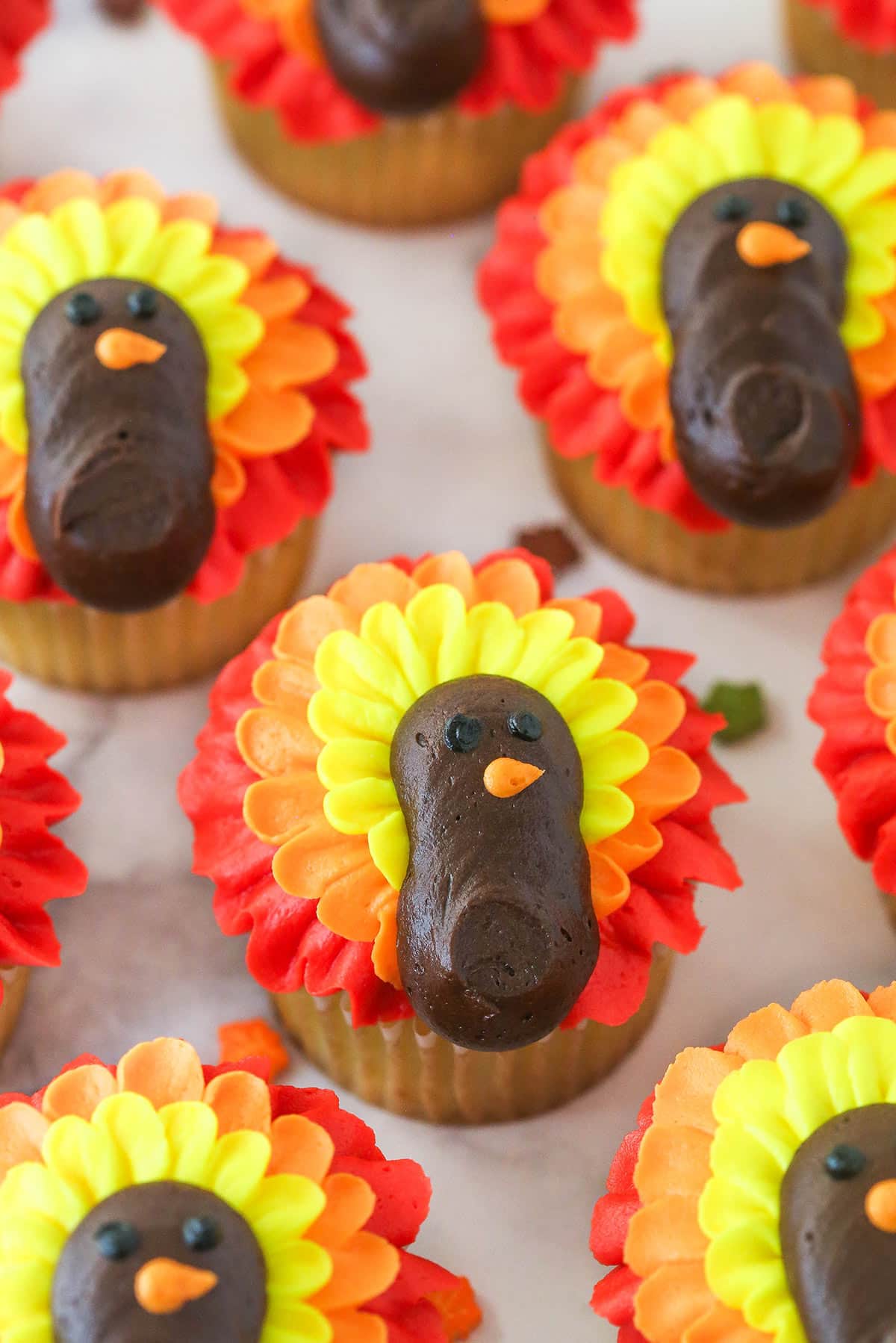 angled close up of turkey cupcakes on marble countertop