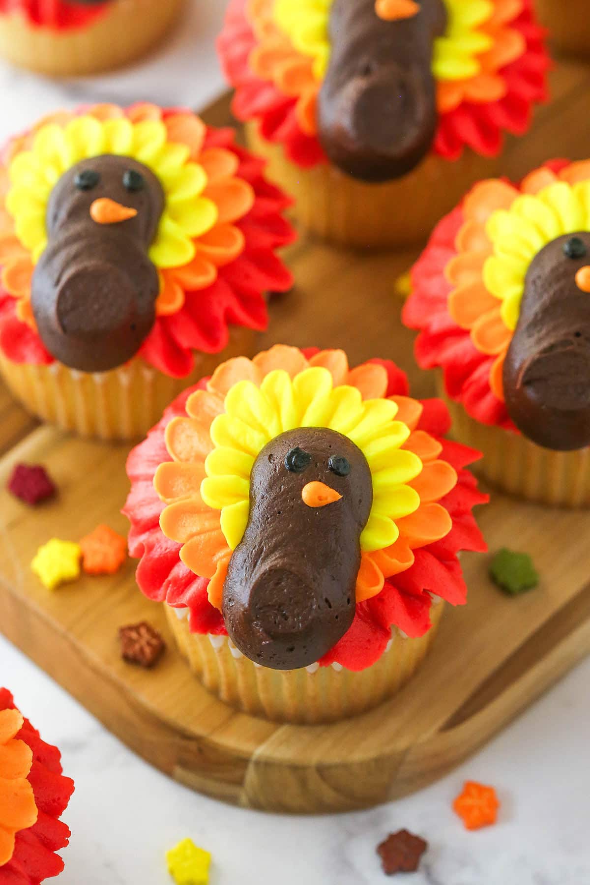 turkey cupcakes on wooden board with leaf sprinkles around