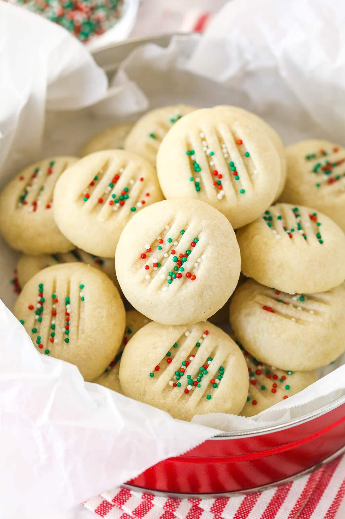 Overhead view of a tin of Christmas whipped shortbread cookies