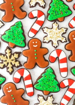 overhead view of chocolate cut out cookies decorated for Christmas