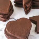 stacks of chocolate cutout cookies on marble counter