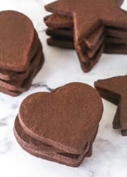 stacks of chocolate cutout cookies on marble counter