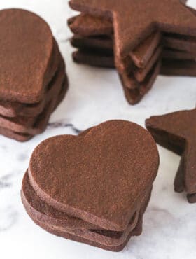 stacks of chocolate cutout cookies on marble counter